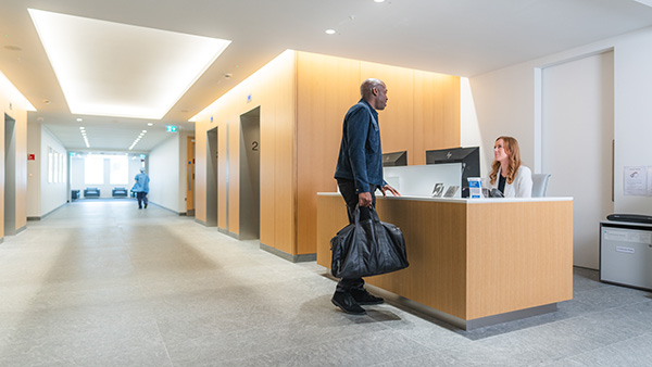 Patient speaking to receptionist.