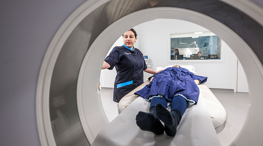 Medical staff performing a CT scan on a patient.