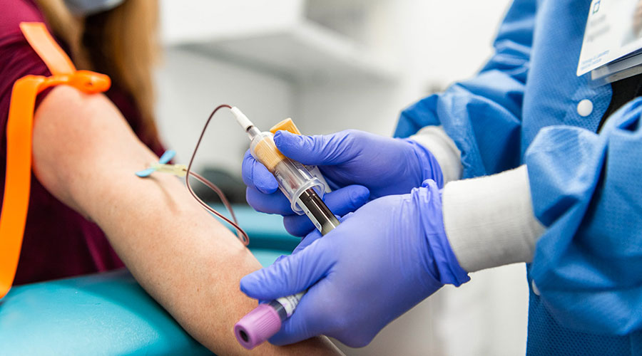Medical nurse drawing blood from a patient's arm.
