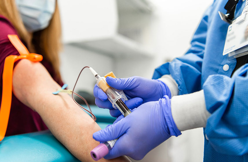 Medical nurse drawing blood from a patient's arm.