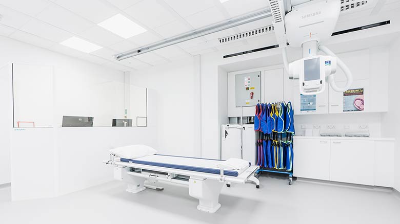 Room with X-ray machine and equipment.