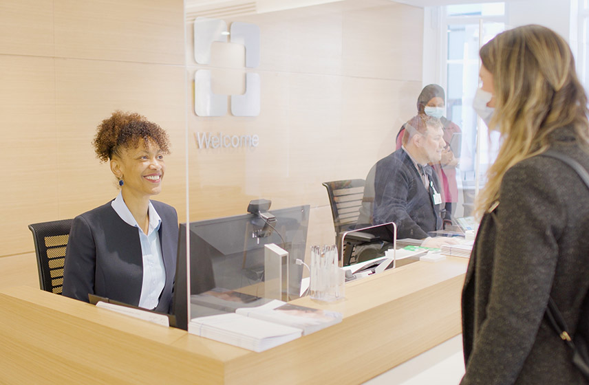 Cleveland Clinic London receptionist talking to patient.