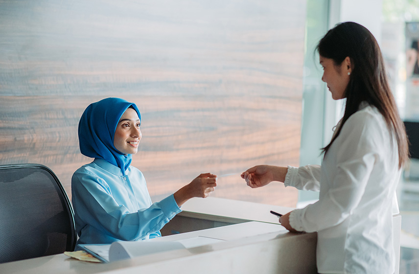 Patient paying at receptionist desk