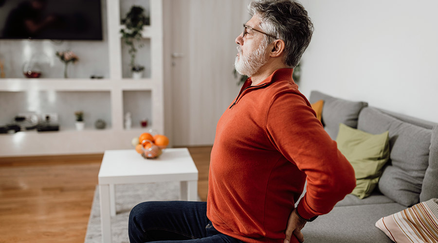 A man stretching his lower back. 