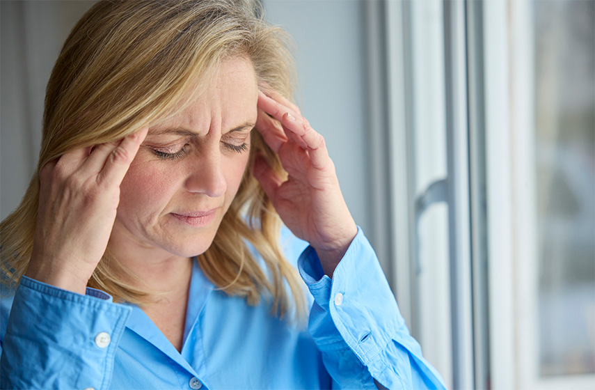 A woman holding the sides of her head