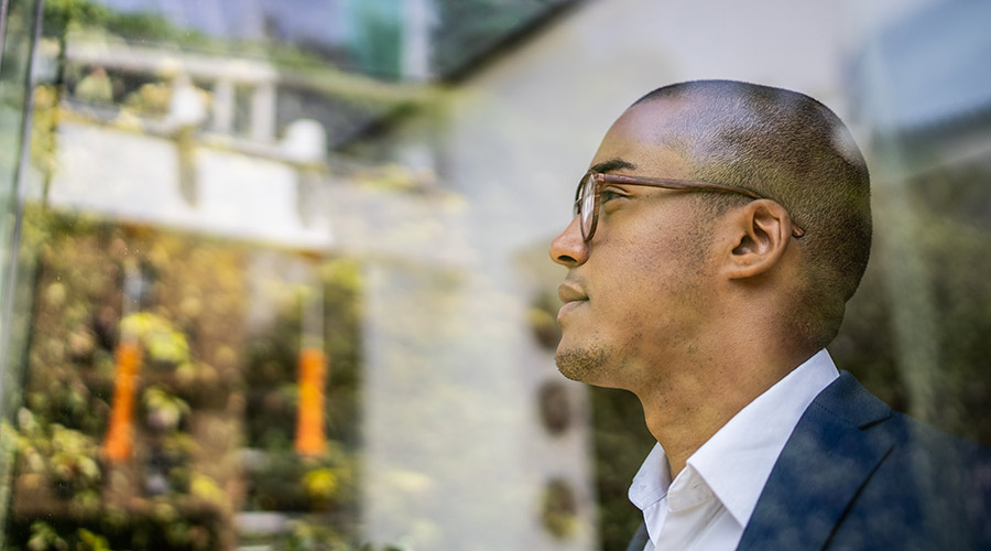 Side profile of a man through a window.