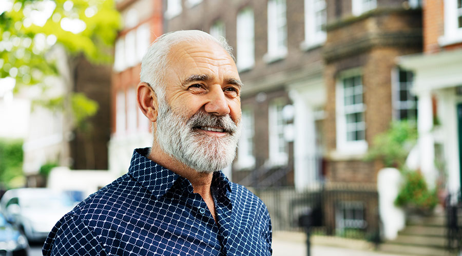 Older man standing outside.