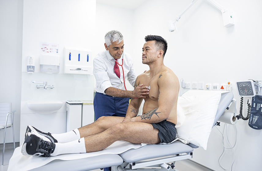 Consultant listening to a patient's heart