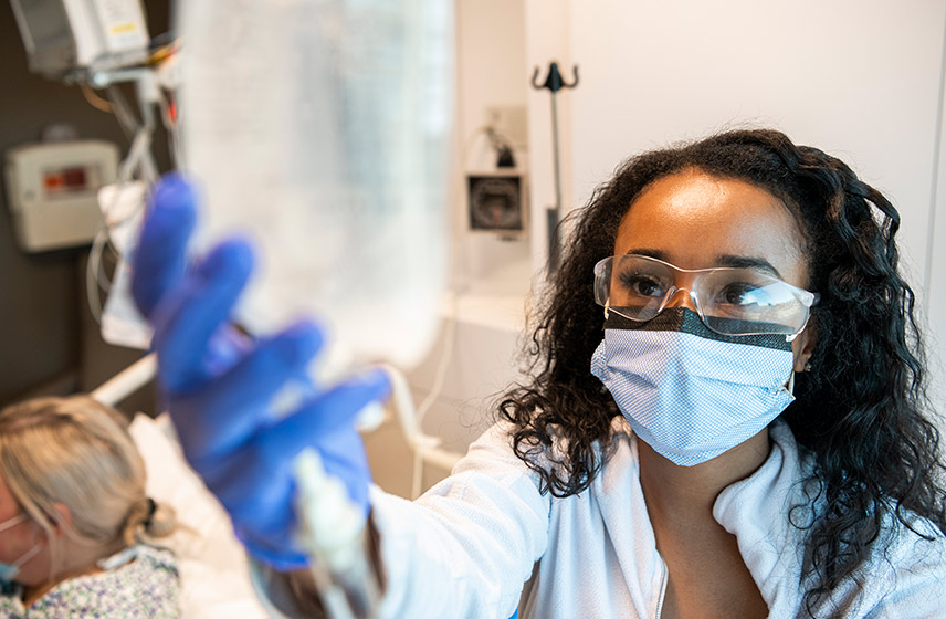 Cleveland Clinic London caregiver hanging an IV bag,