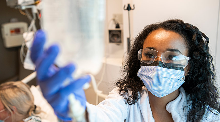 Cleveland Clinic London caregiver hanging an IV bag,