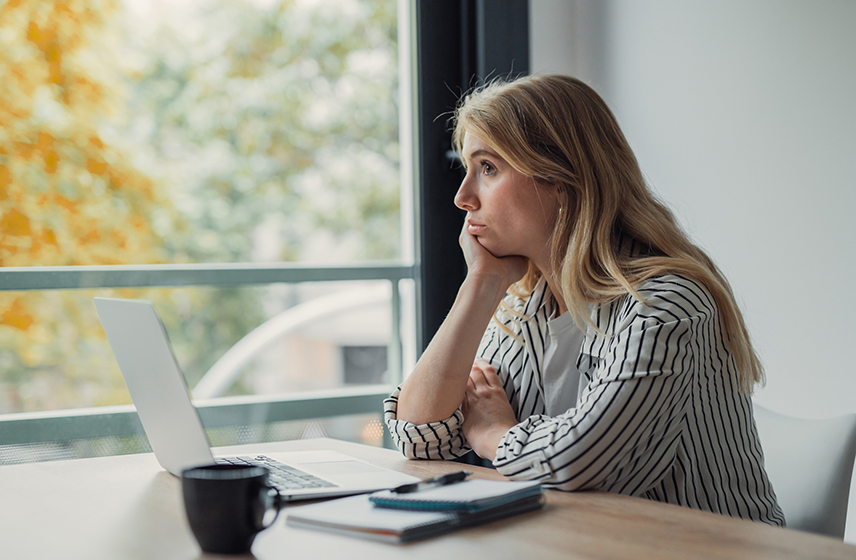 A woman sitting at a table with a laptop