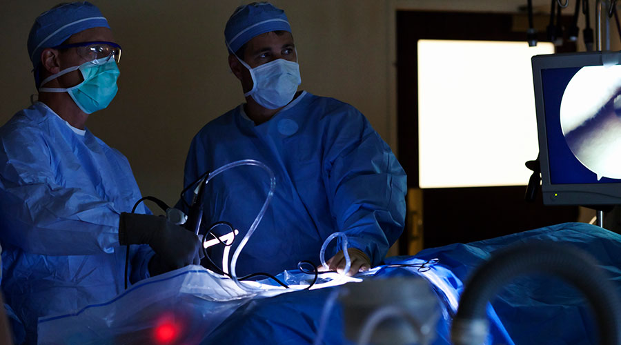 Surgeons performing hip revision surgery.