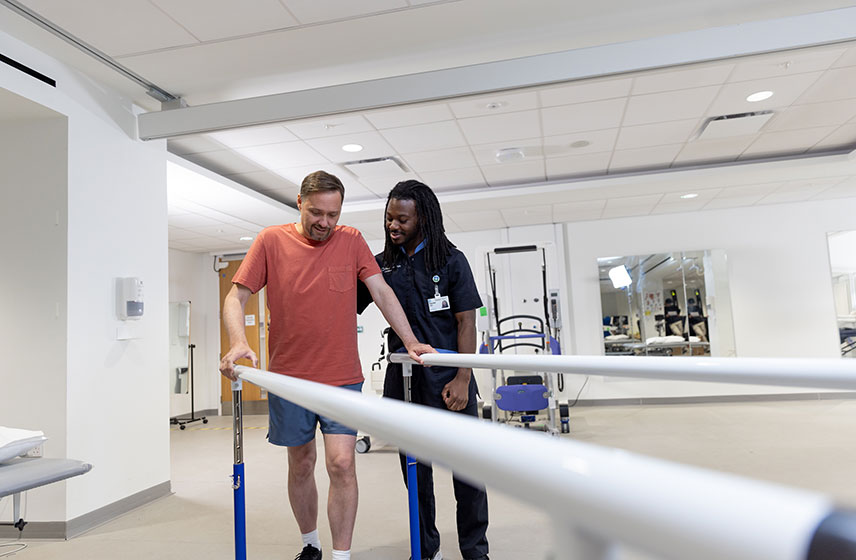 Health professional helping patient learn to walk and balance.