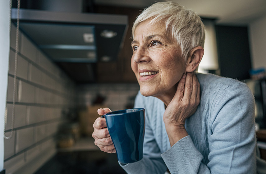 A person holding a cup smiling