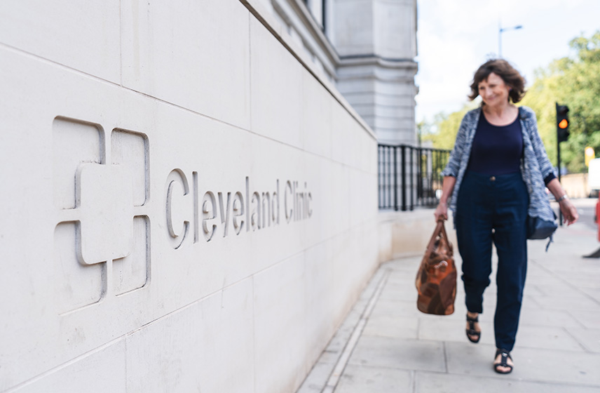 Patient walking next to Cleveland Clinic London building